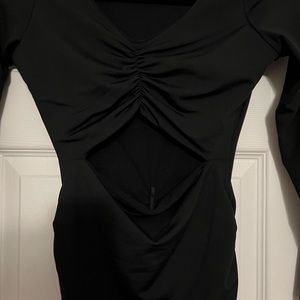 Long sleeve cut out rouched body con in black.